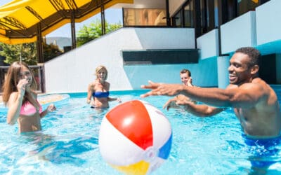 Multi-racial group of friends having fun in a swimming pool.